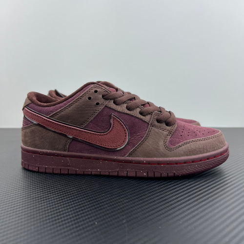 Low-top sneakers in burgundy, pink and dark brown with side swoosh and lace-up.