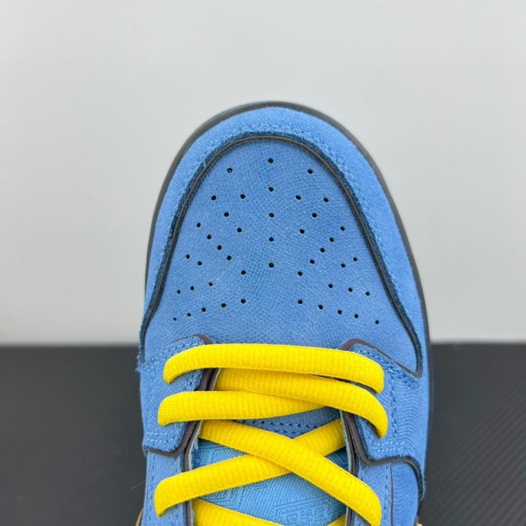 Close-up of blue toe box with perforations and bright yellow lace-up