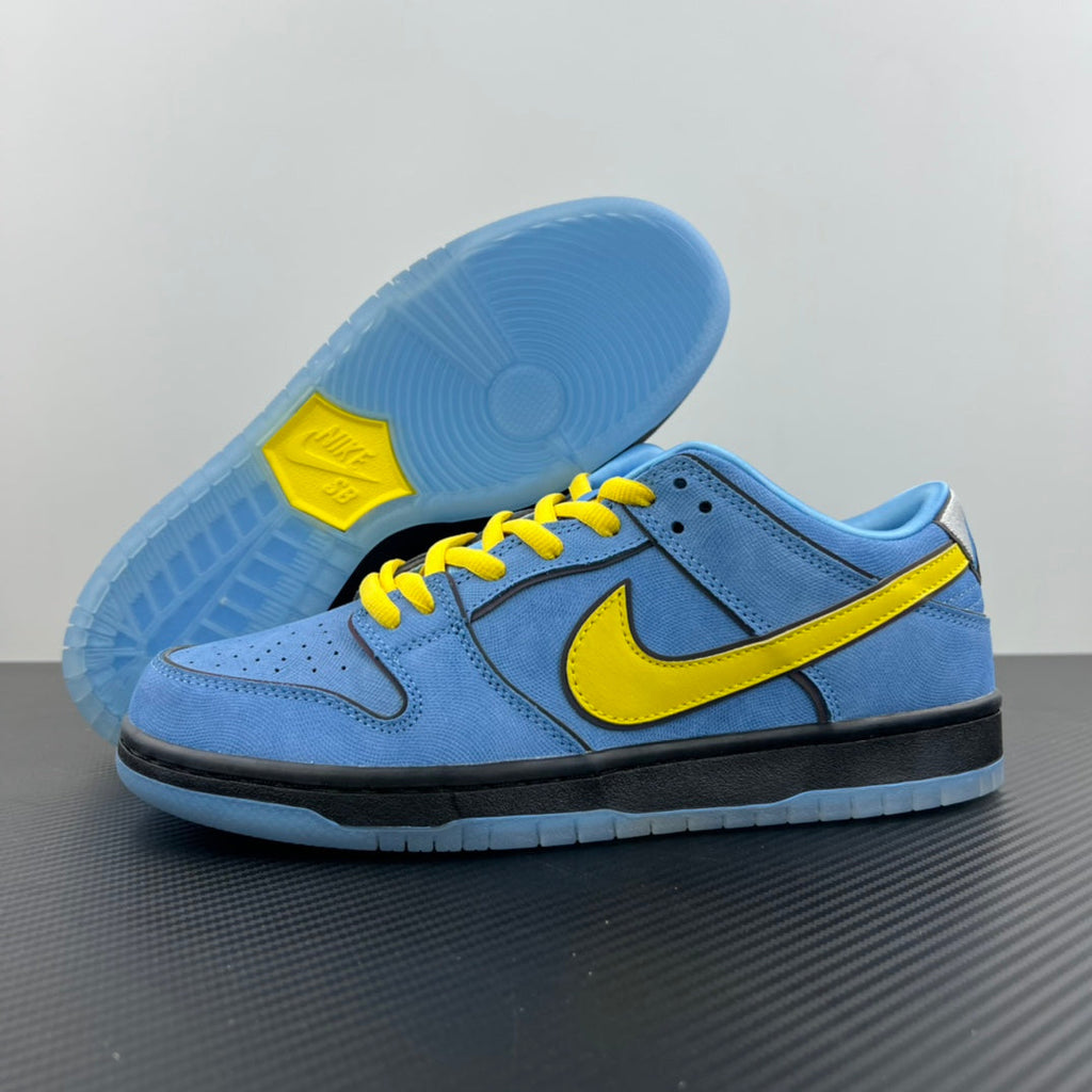 Blue low-top sneakers showing light-blue outsole with yellow logo panel