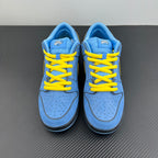 Pair of blue low-top sneakers with yellow laces and black heel trim