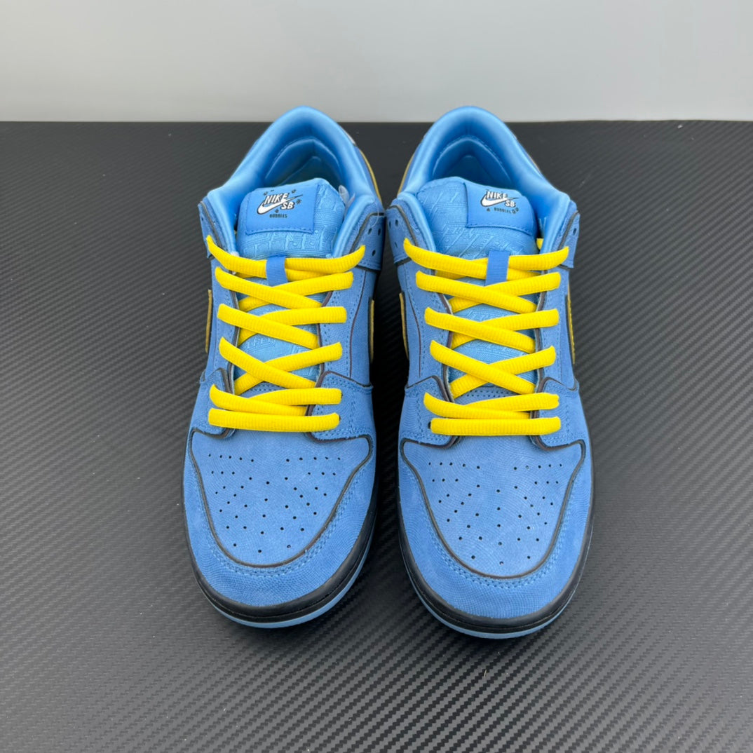 Pair of blue low-top sneakers with yellow laces and black heel trim