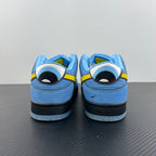 Blue low-top sneakers with graphic patch on heel and yellow lace-up detail