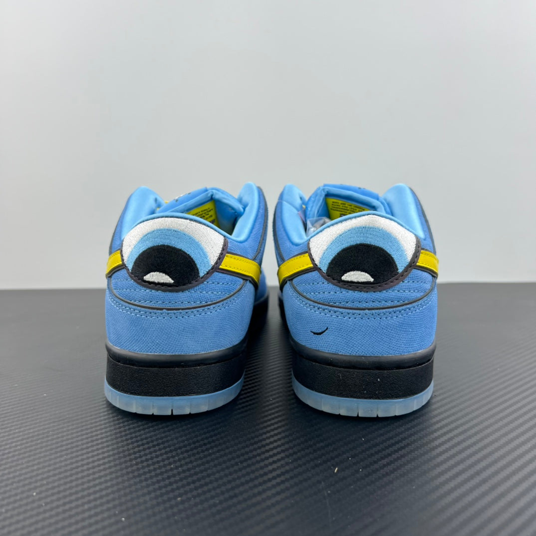 Blue low-top sneakers with graphic patch on heel and yellow lace-up detail
