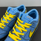 Angled view of blue low-top sneakers with yellow laces and Swoosh on side