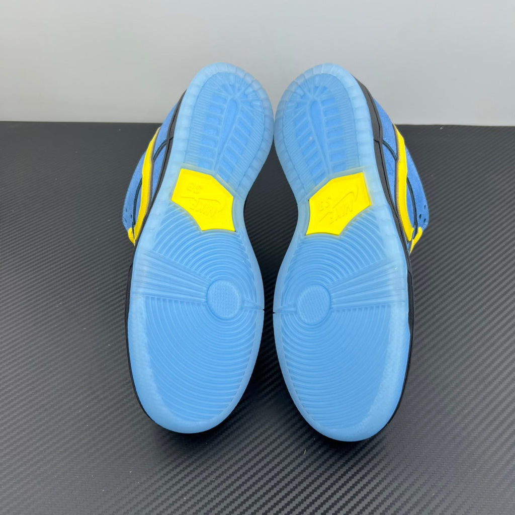 Blue sneaker outsoles with yellow side accents and circular traction pattern