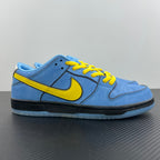 Blue low-top sneakers with yellow Swoosh, black sole, and yellow lace accents