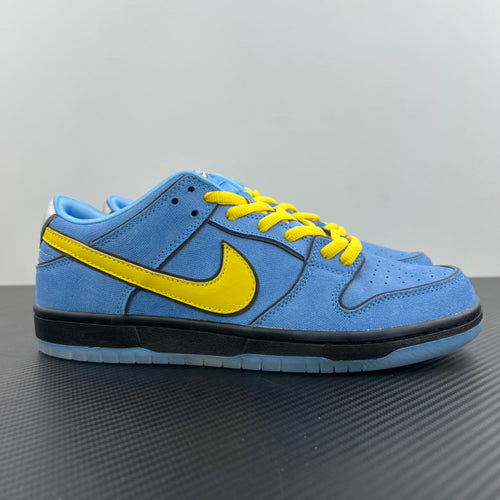 Blue low-top sneakers with yellow Swoosh, black sole, and yellow lace accents