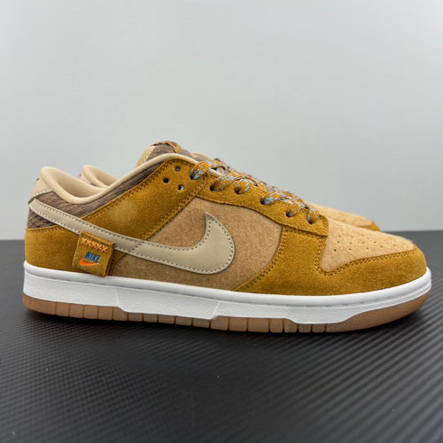 Suede low-top sneakers in mustard and tan with white Nike swoosh and lace-up front
