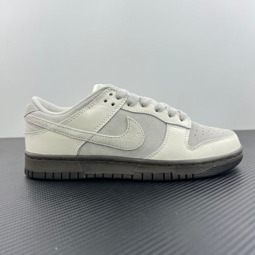 White Nike SB low-top sneakers, side view with lace-up and swoosh.