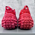 Pair of pink athletic shoes viewed from heels, showing tread and BALENCIAGA text