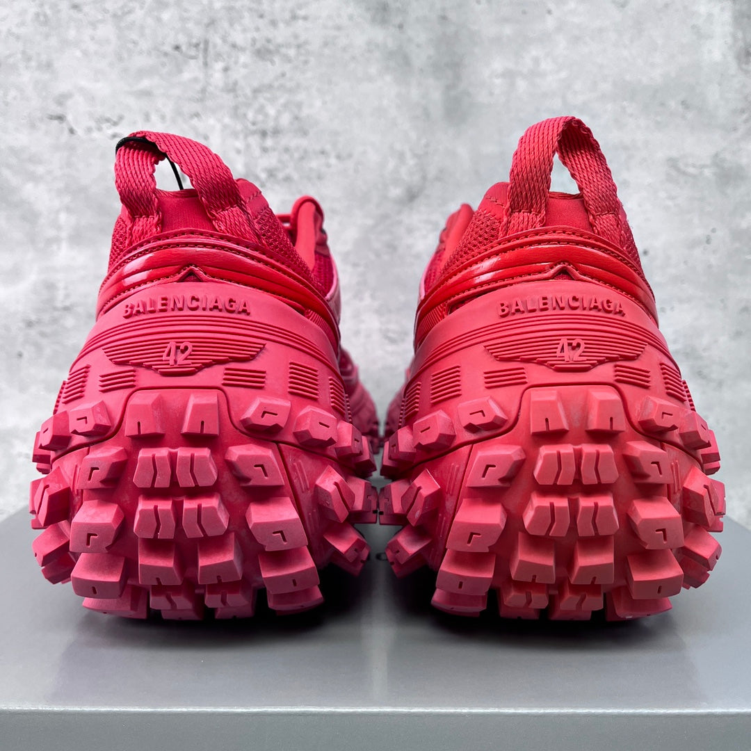 Pair of pink athletic shoes viewed from heels, showing tread and BALENCIAGA text