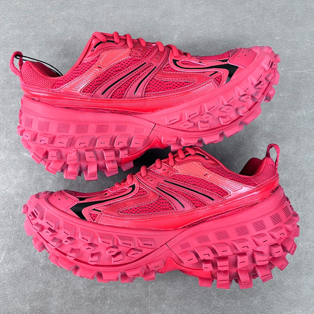 Pair of pink athletic shoes with lace-up fronts and rugged lug soles, top view