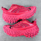 Pair of pink athletic shoes with lace-up fronts and rugged lug soles, top view