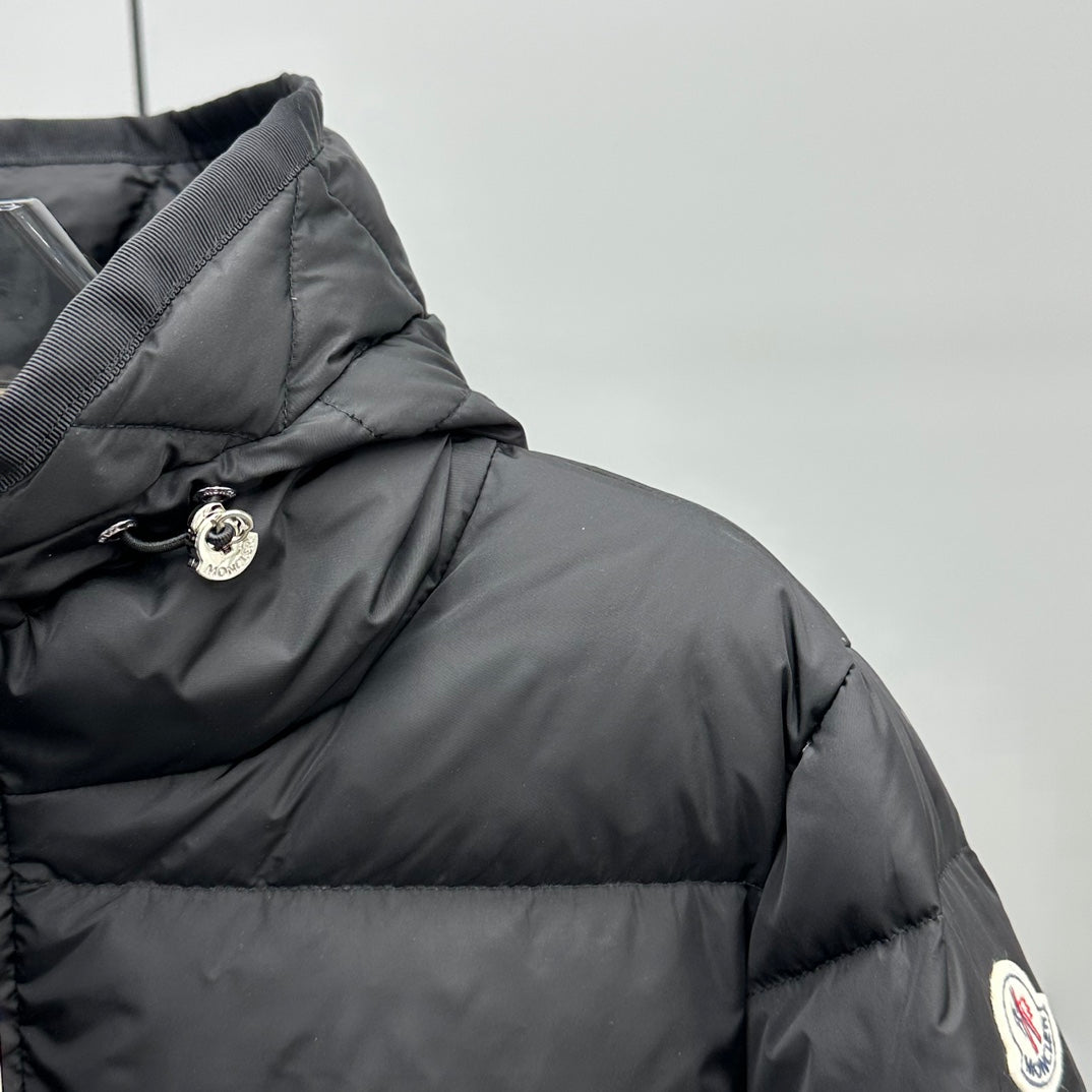 Dark puffer jacket with hood cinch and logo patch on sleeve
