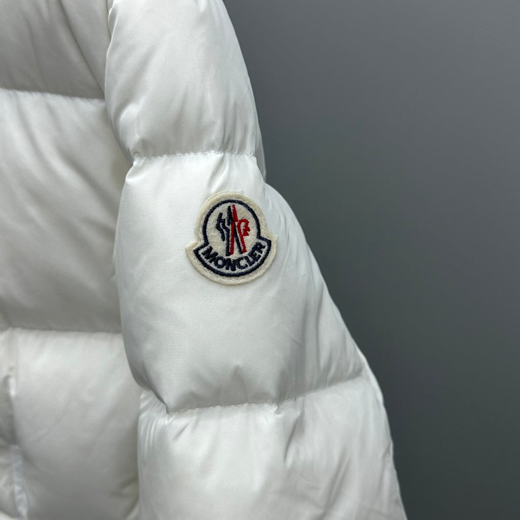 Moncler puffer jacket sleeve, white, circular crest patch on upper arm