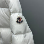 Moncler puffer jacket sleeve, white, circular crest patch on upper arm