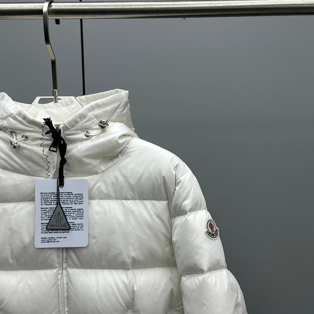 Moncler hooded puffer jacket, white, side view with sleeve patch and hanging tag