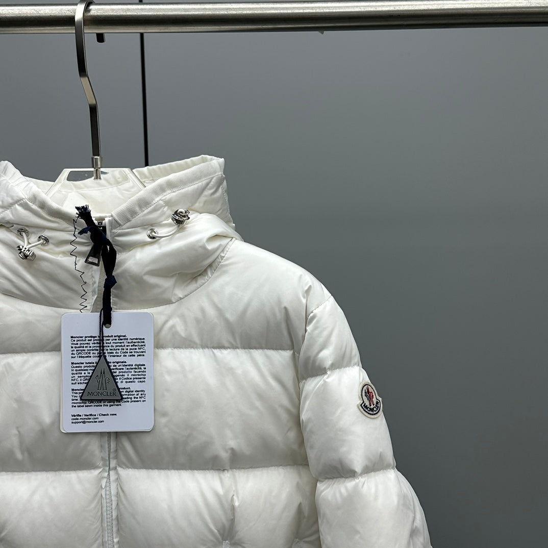 Moncler hooded puffer jacket, white, side view with sleeve patch and hanging tag