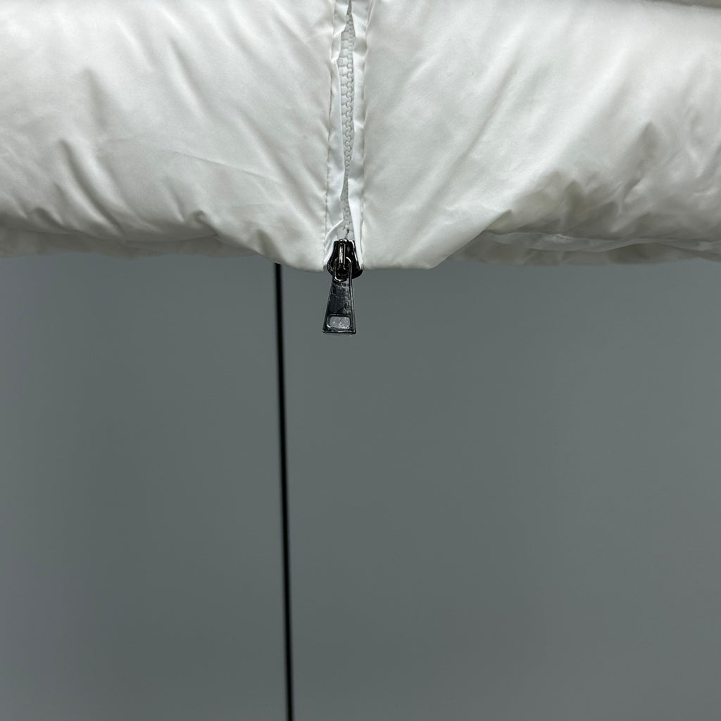Moncler white puffer jacket close-up of front zipper and black pull tab