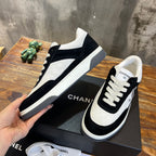 Chanel unisex sneakers with black and white color blocking and lace-up closure
