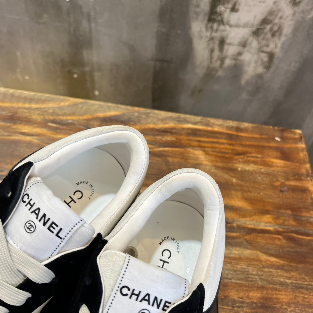 Chanel unisex sneakers heel view with CHANEL branding on the back collar