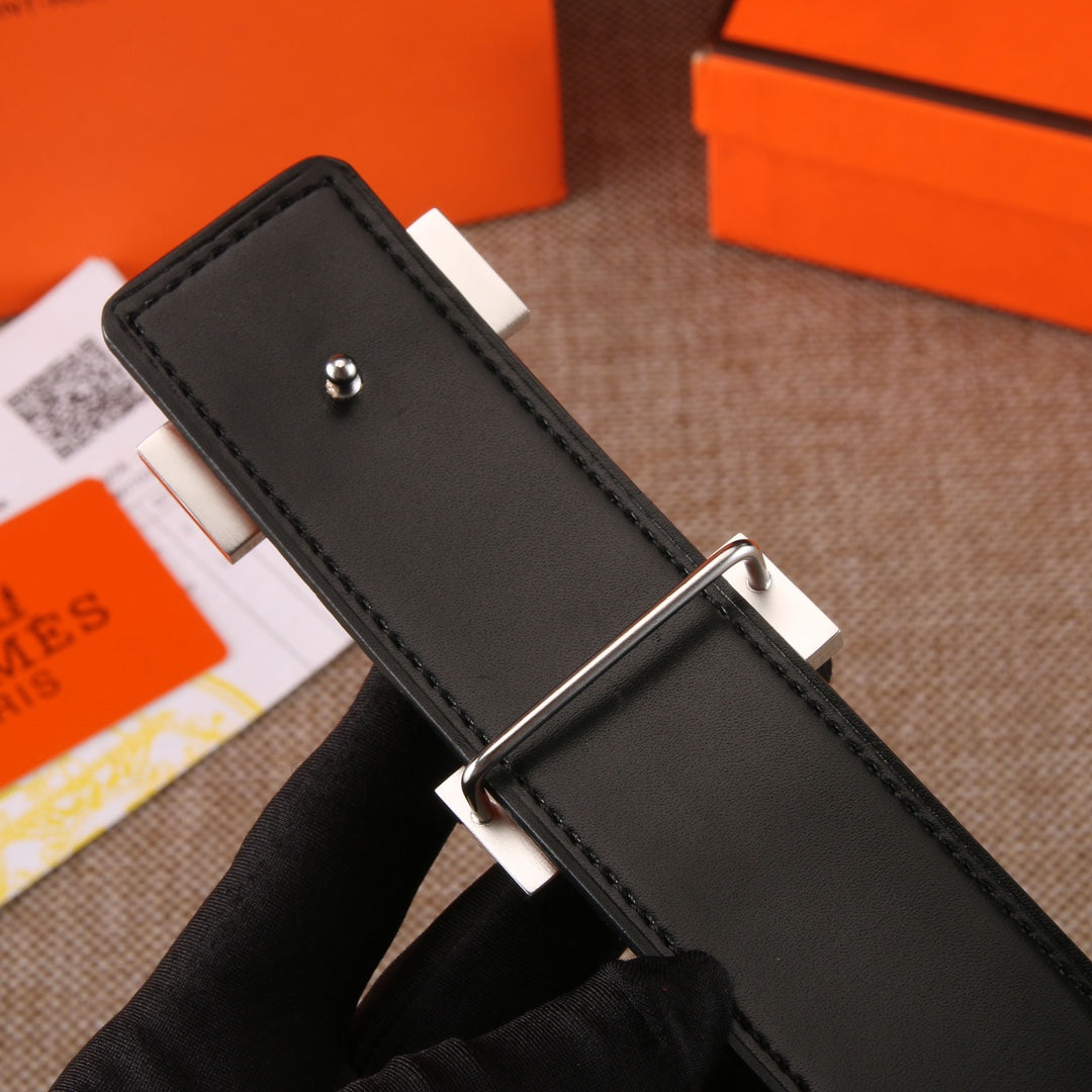 Leather belt with black strap and silver buckle prong fastening