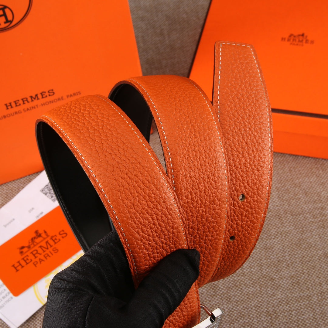 Leather belt with orange strap, visible holes, and edge stitching