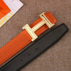 Leather belt with orange strap, silver H buckle, and black backing strap