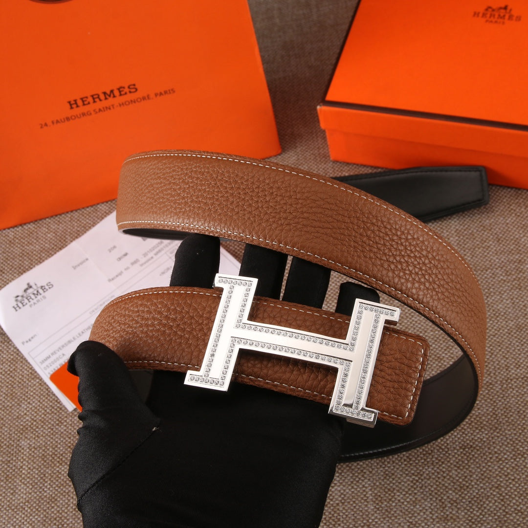 Brown leather belt with silver-tone H buckle, rows of holes, and black keeper