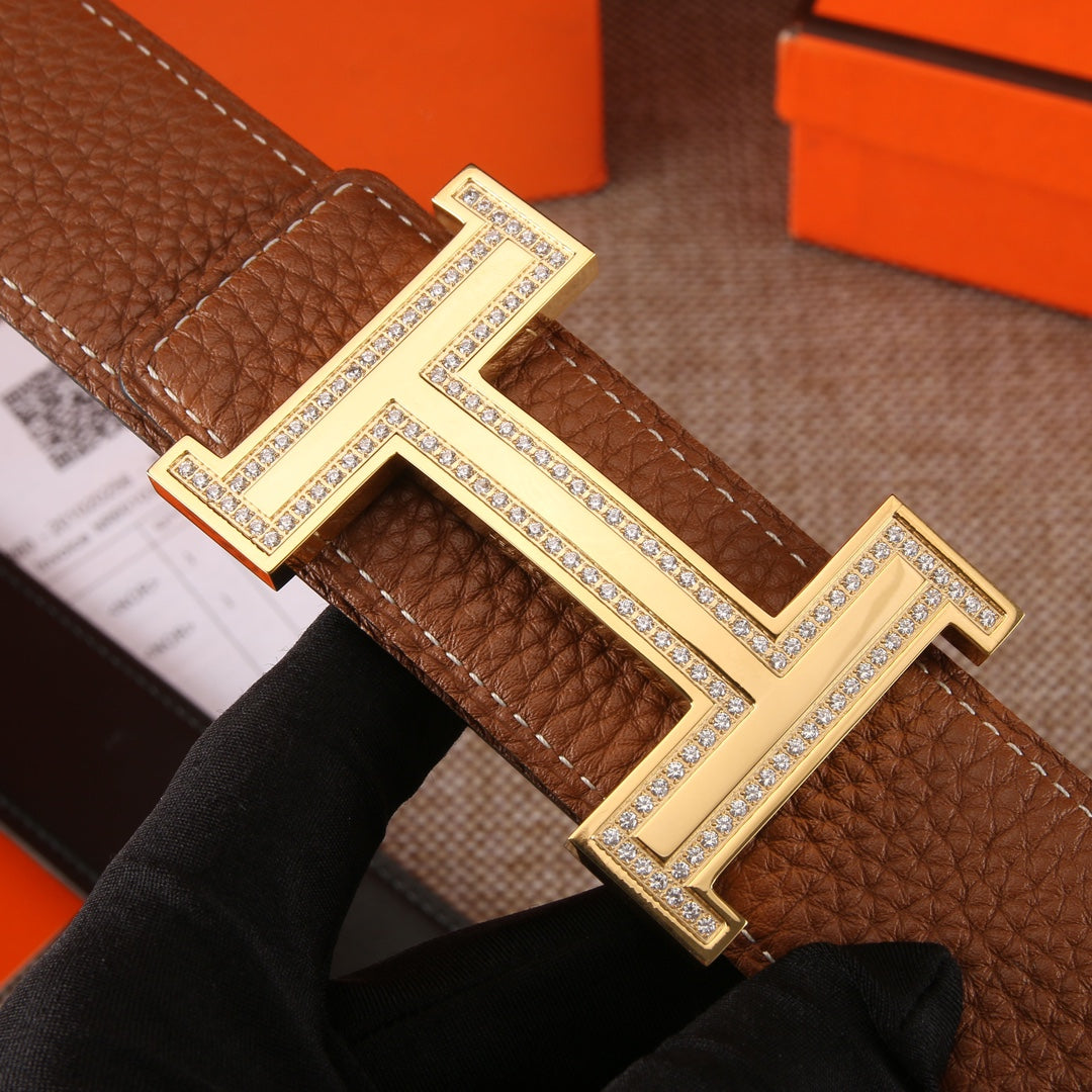 Brown leather belt with oversized H buckle; silver-tone borders and rhinestone details