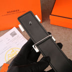 Black leather belt with silver-tone buckle hardware and pin on keeper tab