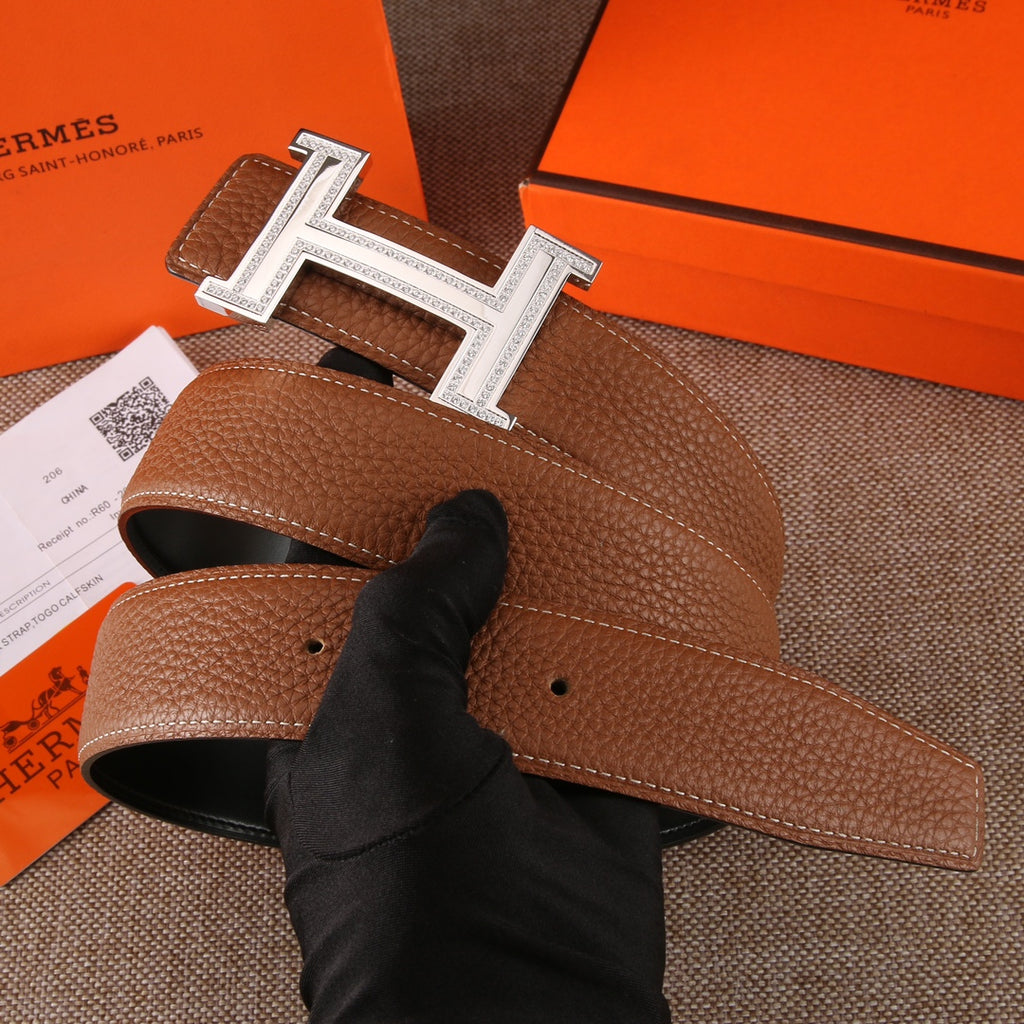 Brown leather belt with silver-tone H buckle; inner edge and adjustable holes visible