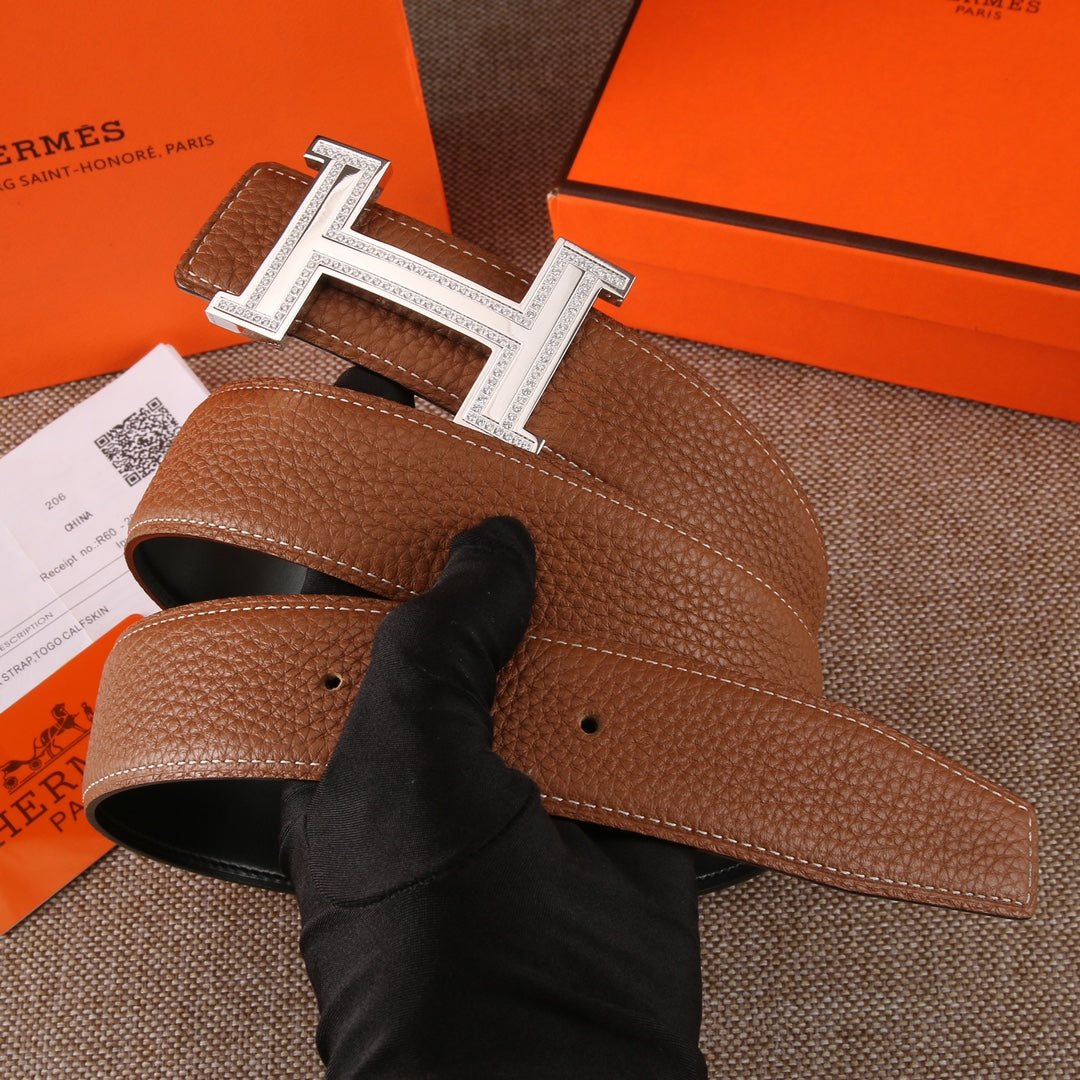 Brown leather belt with silver-tone H buckle; inner edge and adjustable holes visible