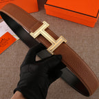 Brown leather belt with studded H buckle and gold-tone metal frame