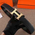 Black leather belt with textured finish and gold-tone H buckle