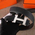 Black leather belt with gold-tone H buckle and engraved-style centerpiece