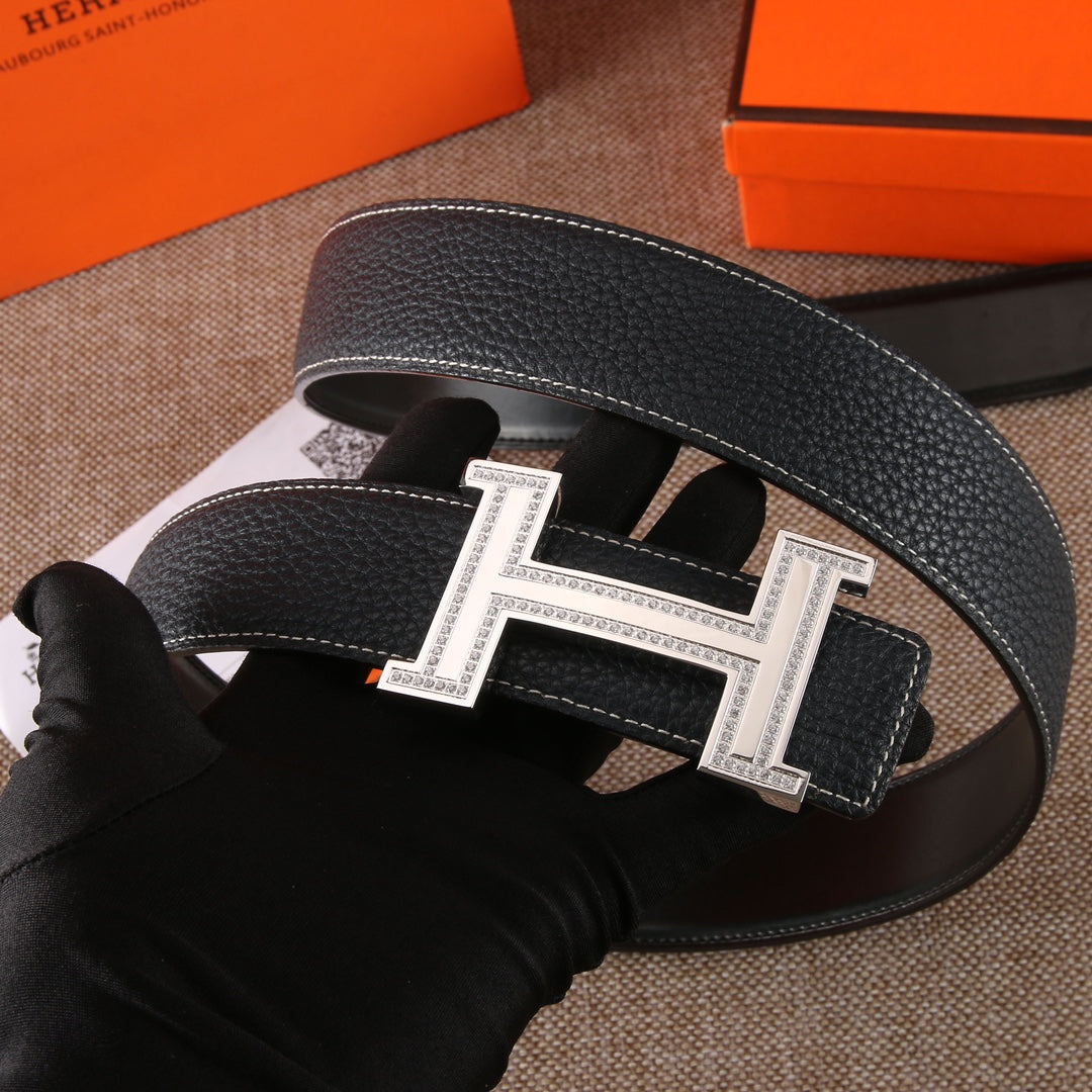 Black leather belt with gold-tone H buckle and engraved-style centerpiece