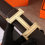 Hermes leather belt detail: dark brown strap with gold H buckle and rhinestone border