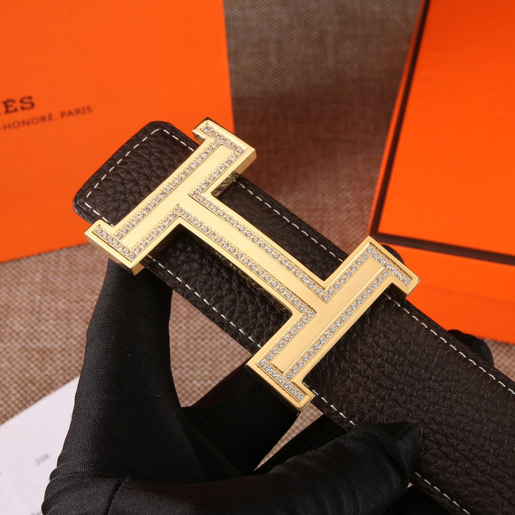 Hermes leather belt with dark brown strap and large gold H buckle, rhinestone edged