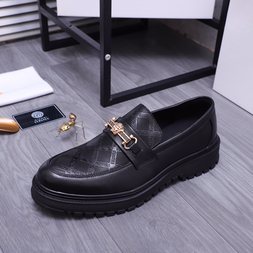 Versace luxury loafers in black, textured upper with gold buckle strap
