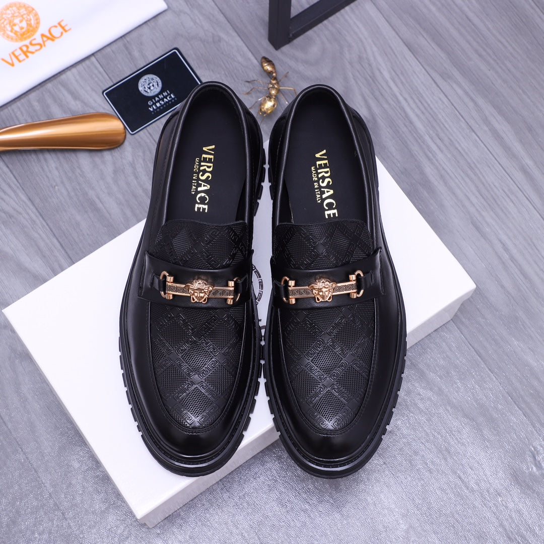 Versace luxury loafers, black textured leather with gold buckle ornament