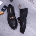 Versace luxury loafers, black pair with gold buckle detail and chunky sole