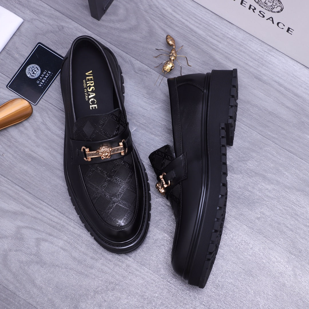 Versace luxury loafers, black pair with gold buckle detail and chunky sole