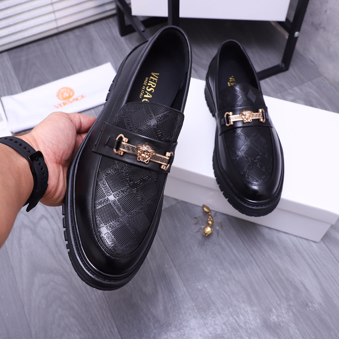 Versace luxury black loafers, gold buckle strap and textured upper