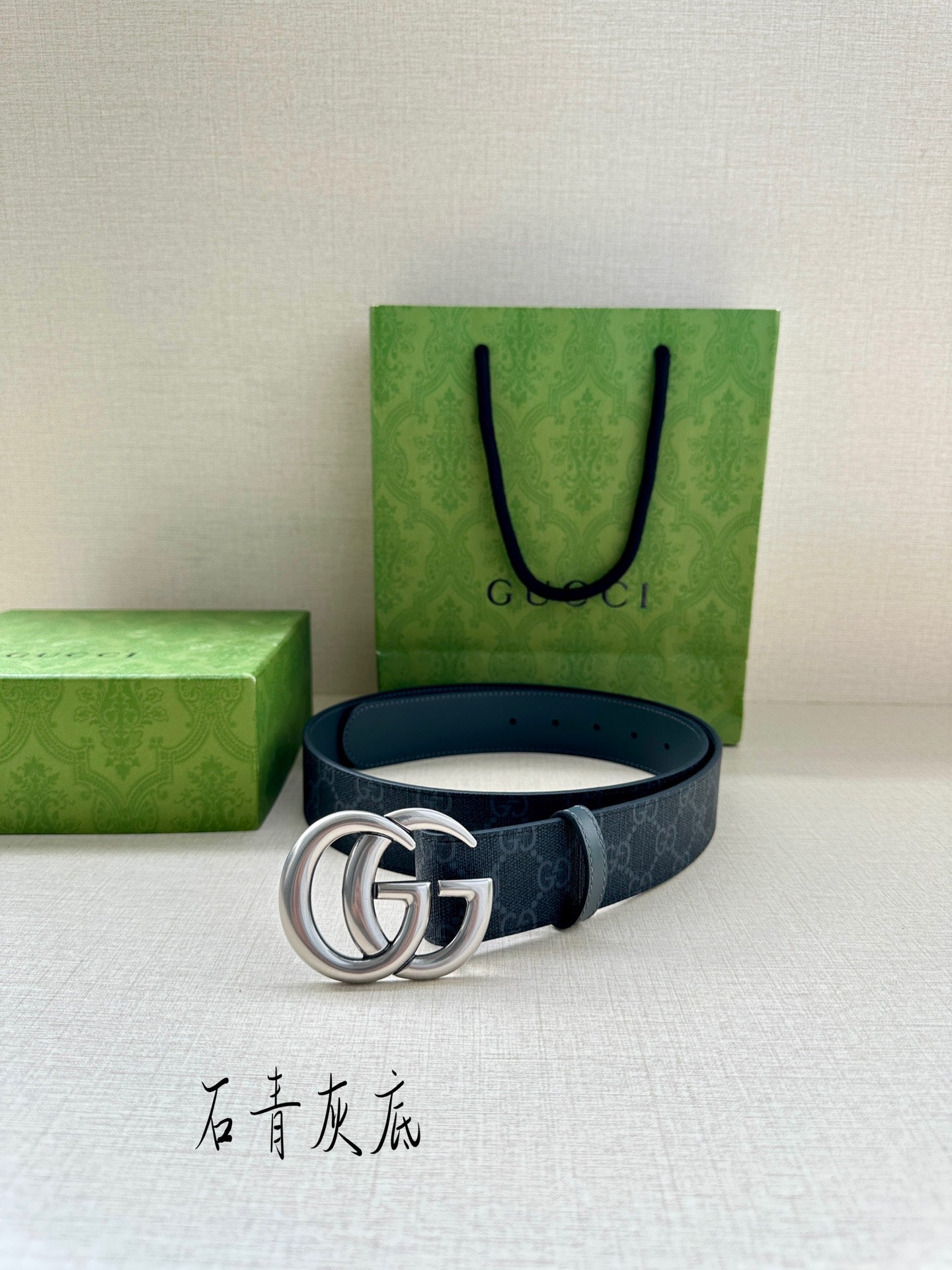 Gucci belt with dark blue monogram strap and silver-tone interlocking GG buckle