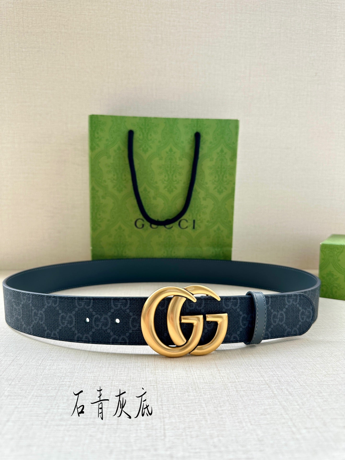 Gucci belt with dark blue monogram strap and gold-tone GG buckle