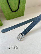 Gucci belt laid flat: dark blue monogram strap with silver-tone GG buckle