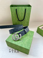 Gucci belt on green box: dark blue monogram strap with silver-tone GG buckle