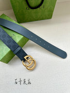 Gucci belt with dark blue monogram strap, gold-tone GG buckle, and belt holes