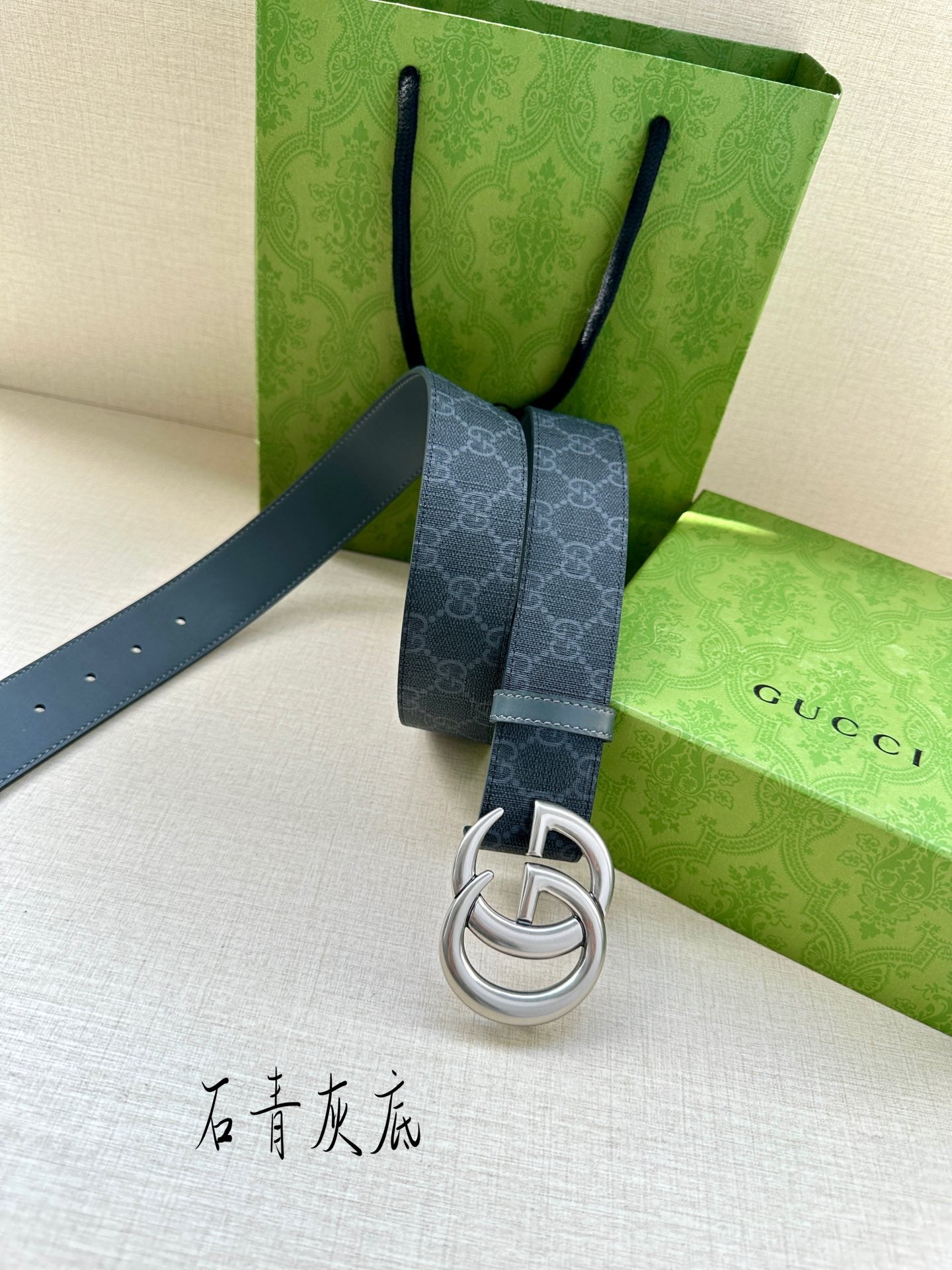 Gucci belt detail: dark blue monogram strap with silver-tone GG buckle